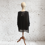 TUNICA ,blusa en gasa de seda, color negro dibujo de flores y detalle en bajo de lentejuelas